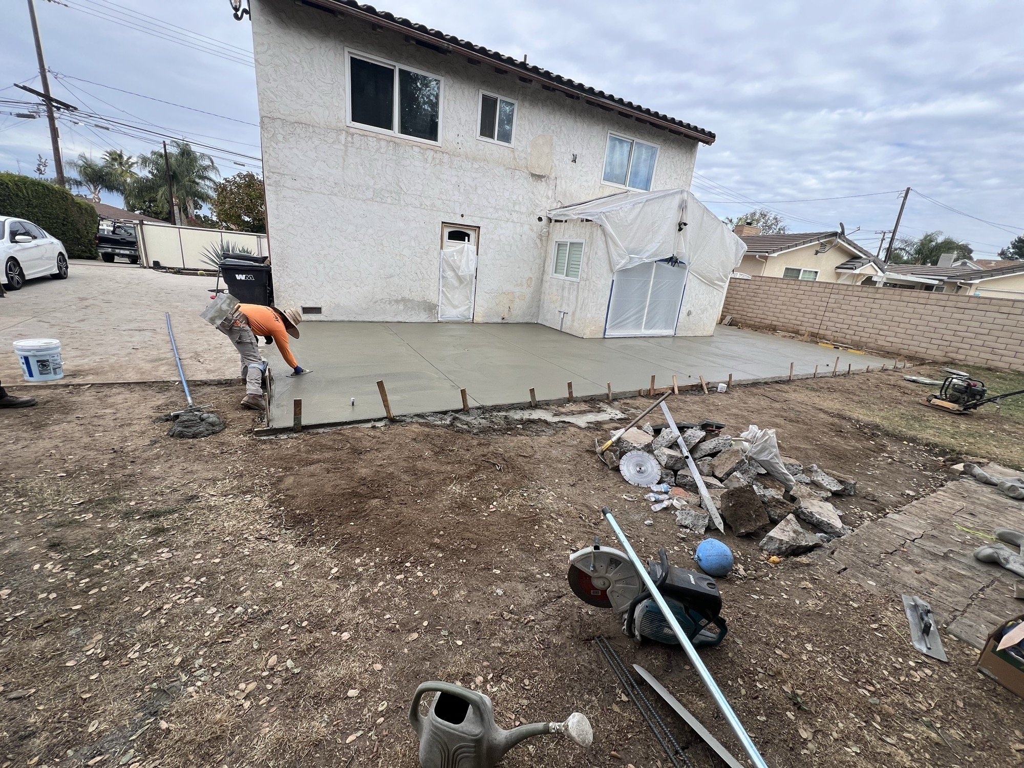 Crew finishing a freshly poured residential slab